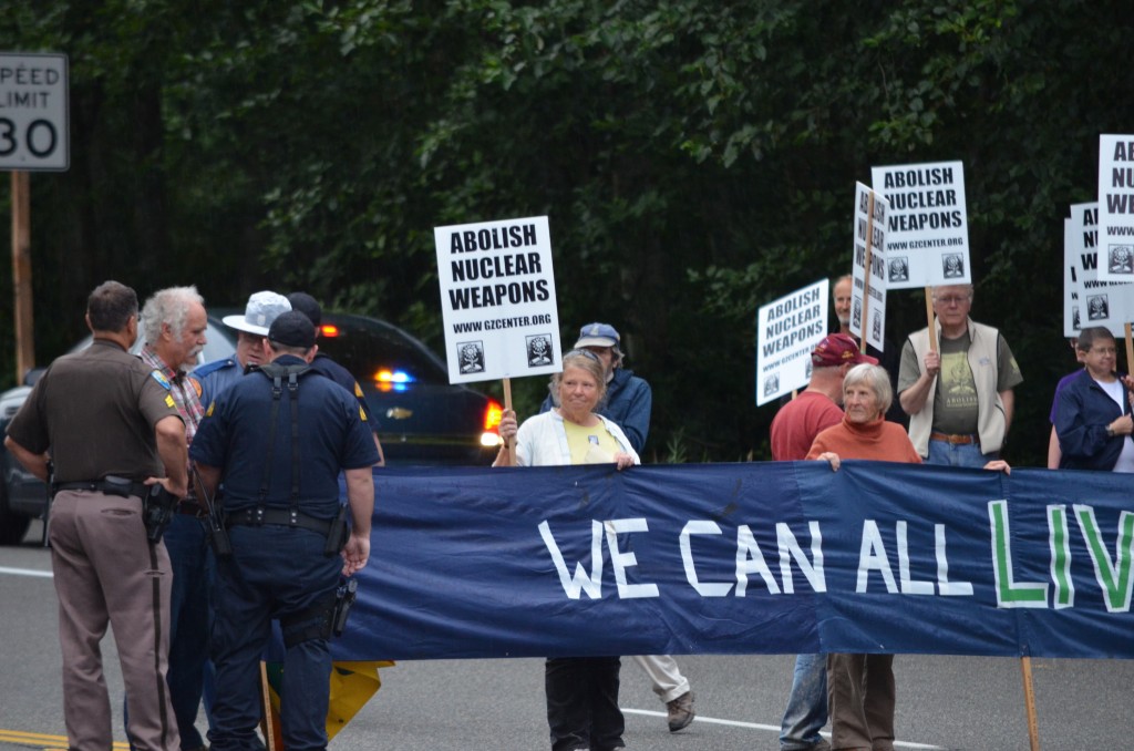 Doug (at far left) during the August blockade as State Patrol officers move resisters off the roadway. (photo by Glen Milner)